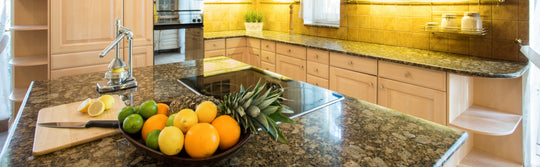Granite countertop surface with oranges and lemons in the kitchen